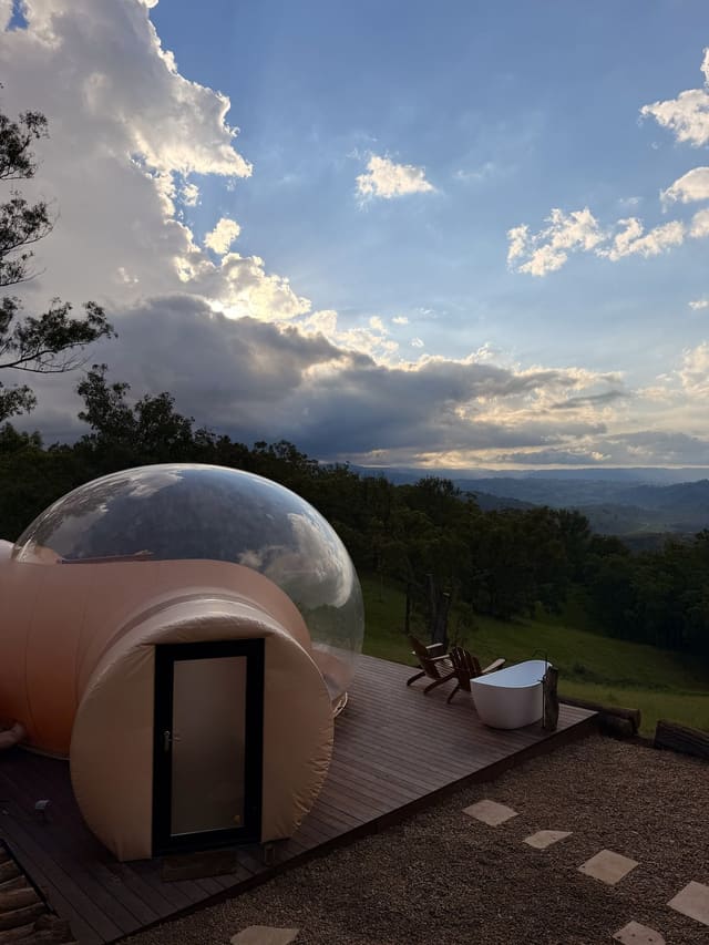 Bubble dome on a timber deck with an outdoor bath overlooking the Megalong Valley.